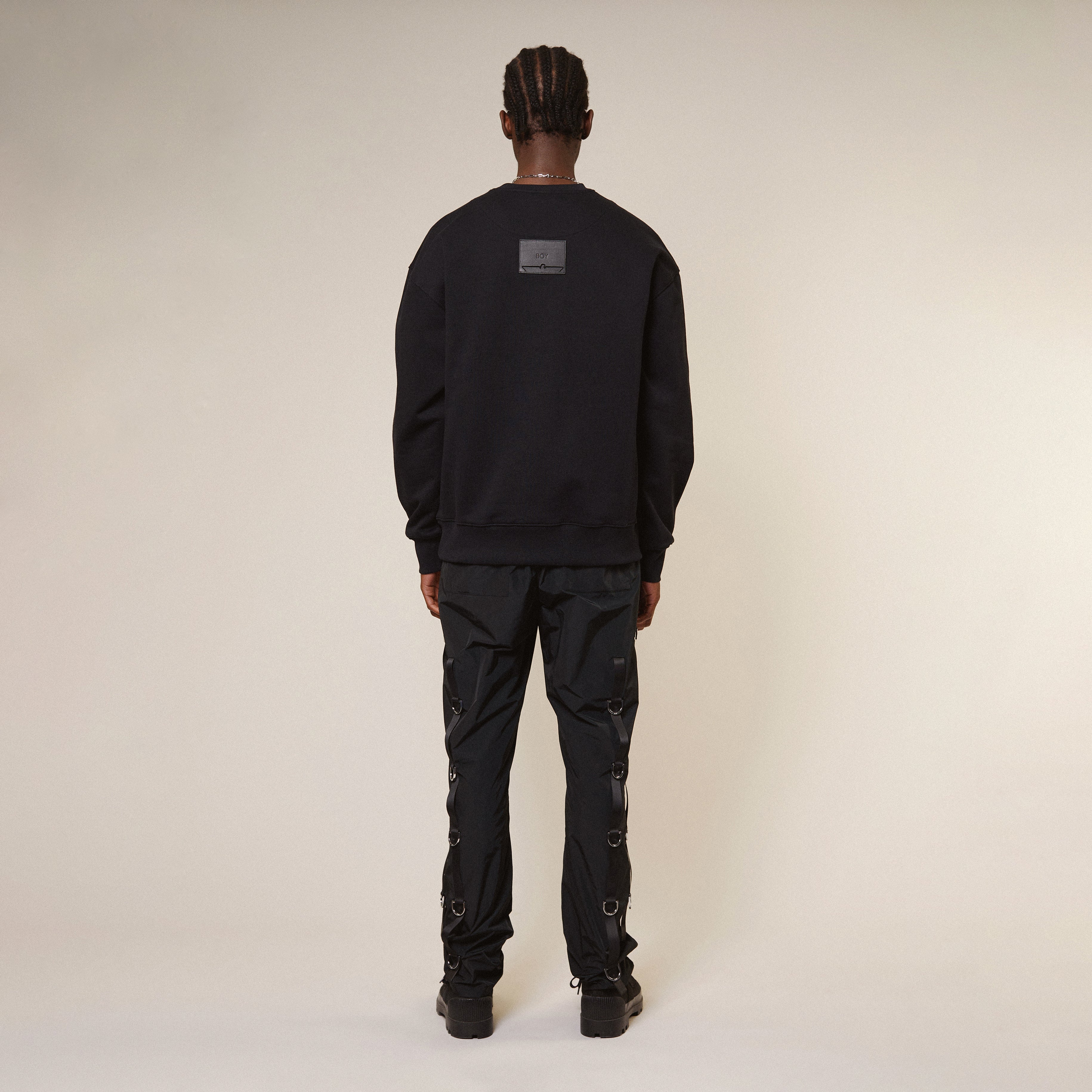 Model wearing Black Boy London sweatshirt with a graphic design on a white background