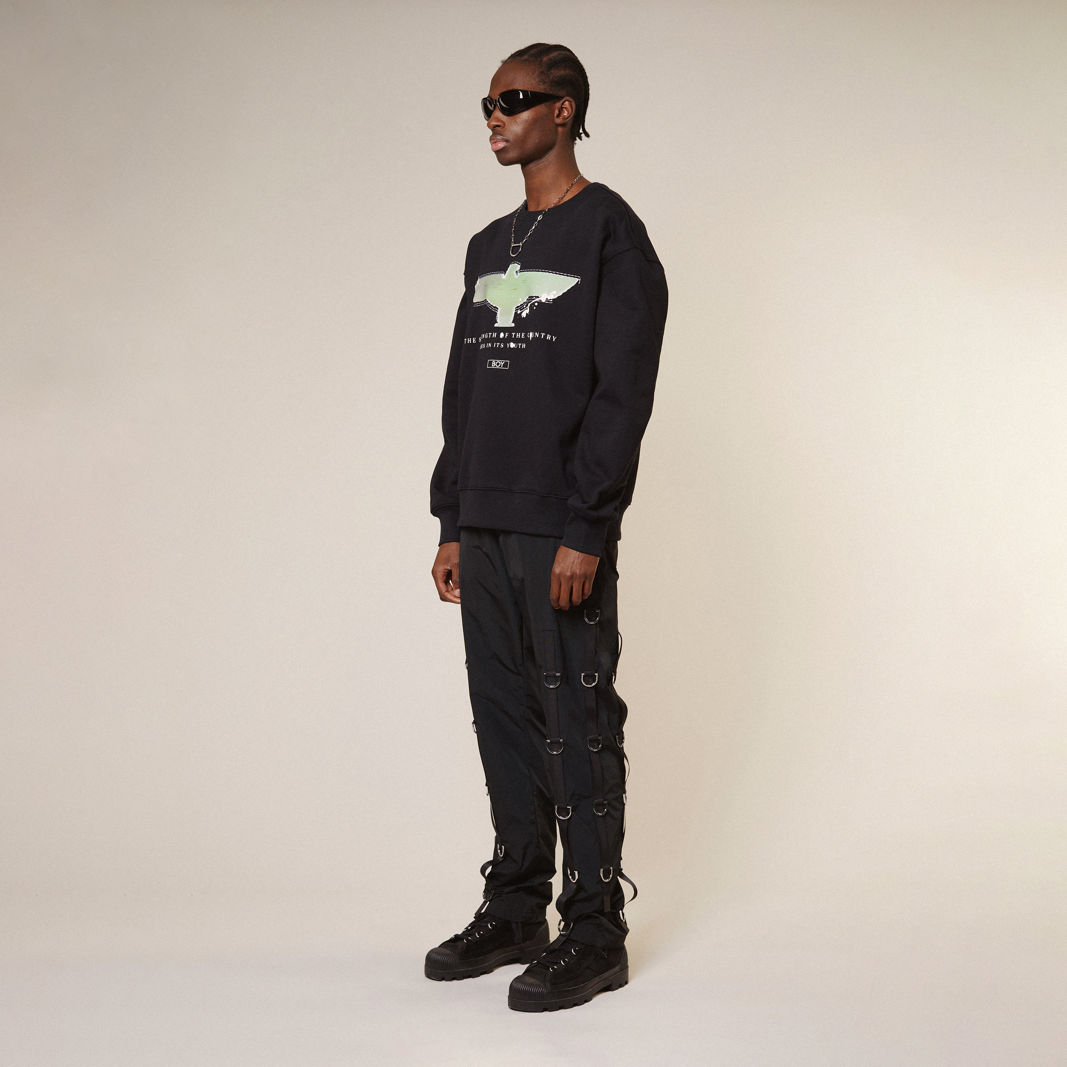 Model wearing Black Boy London sweatshirt with a graphic design on a white background