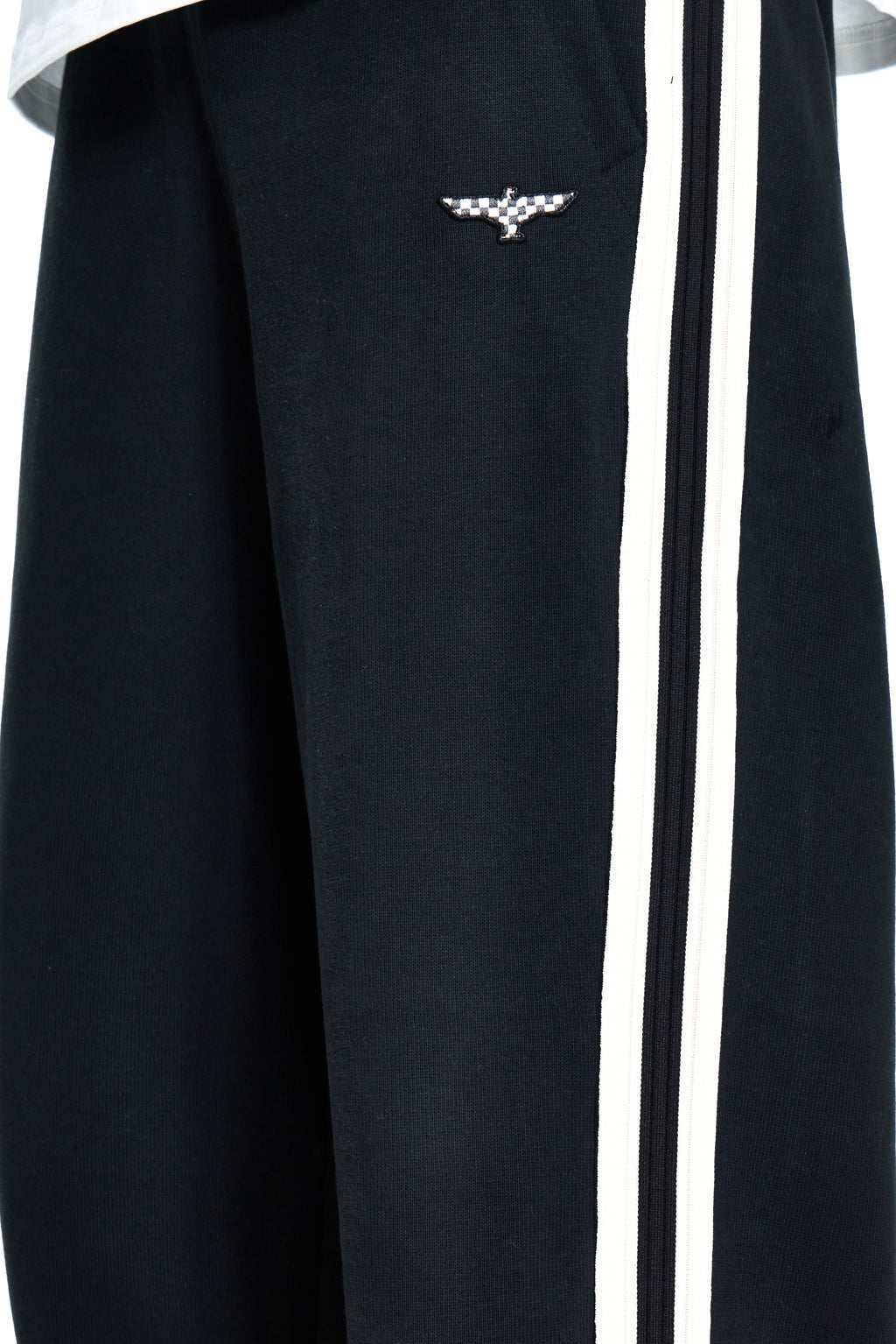 Black tracksuit with white stripes and a logo on the chest.