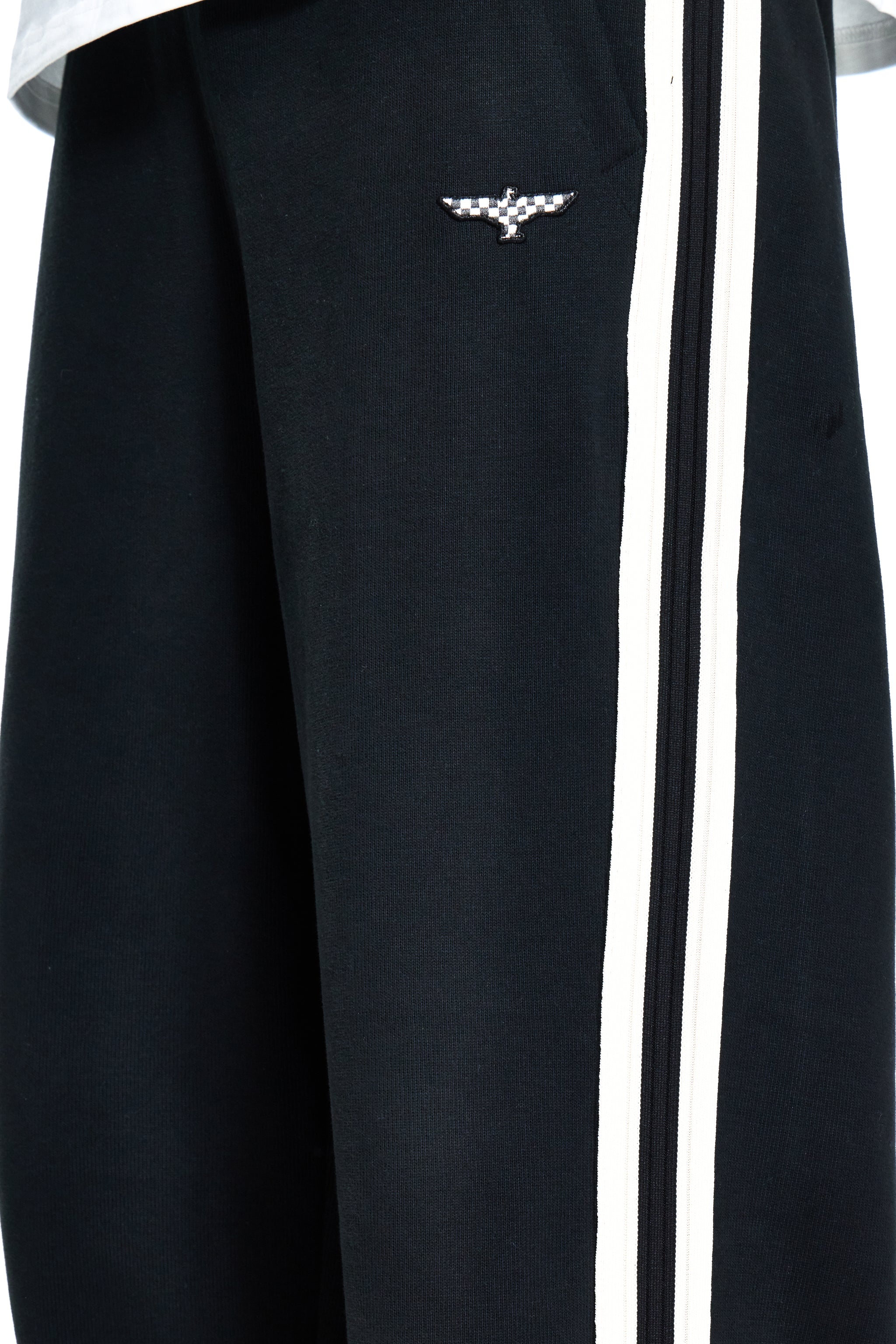 Black tracksuit with white stripes and a logo on the chest.