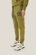 Model wearing green BOY London tracksuit with brand logo on a white background