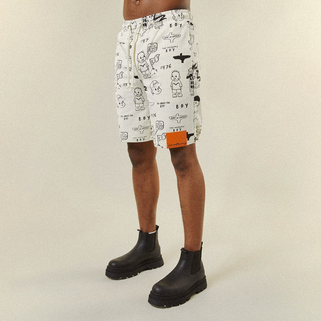 Model wearing BOY London shorts on plain background 