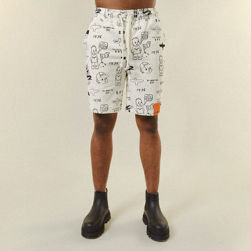 Model wearing BOY London shorts on plain background 