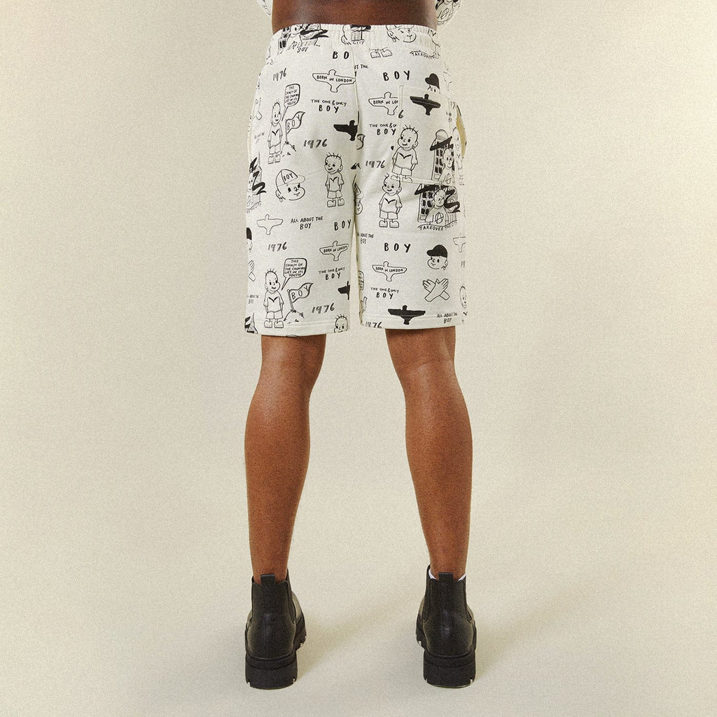 Model wearing BOY London shorts on plain background 
