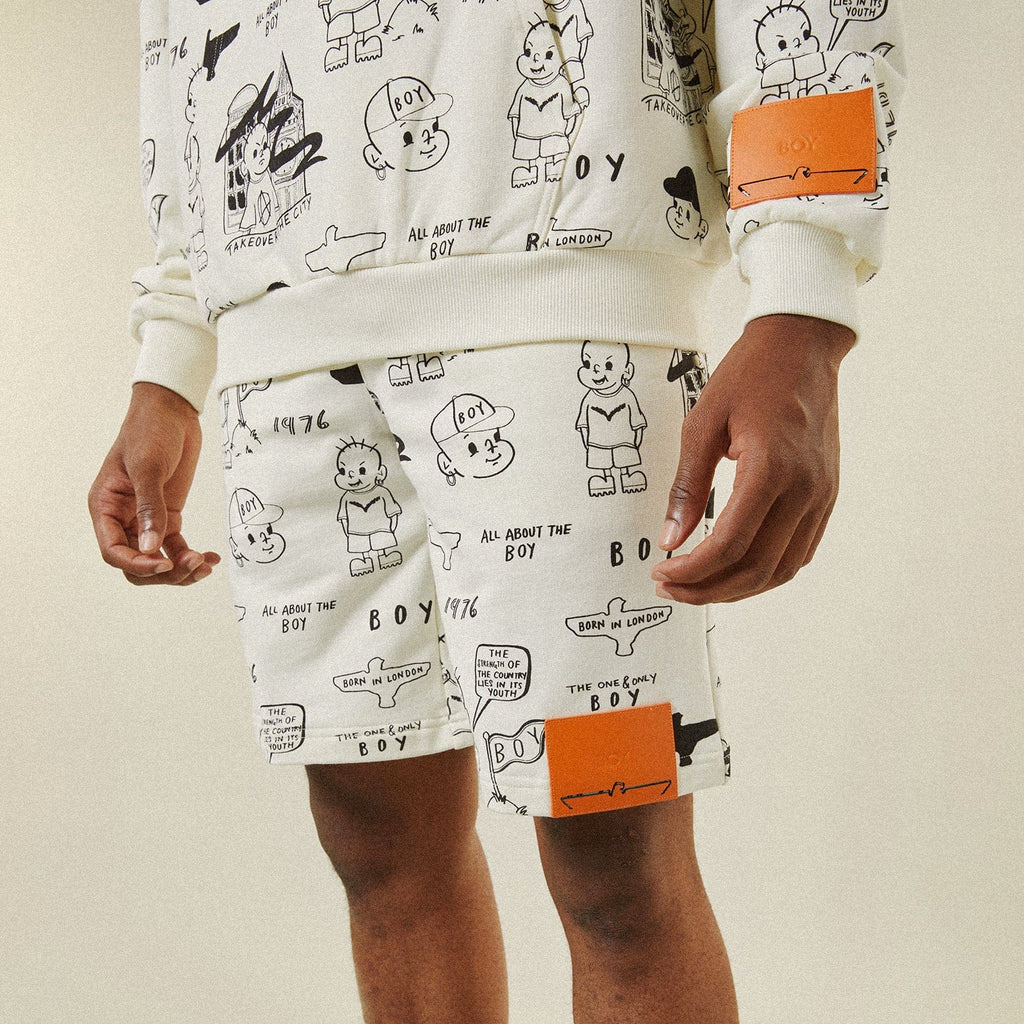 Model wearing BOY London shorts on plain background 
