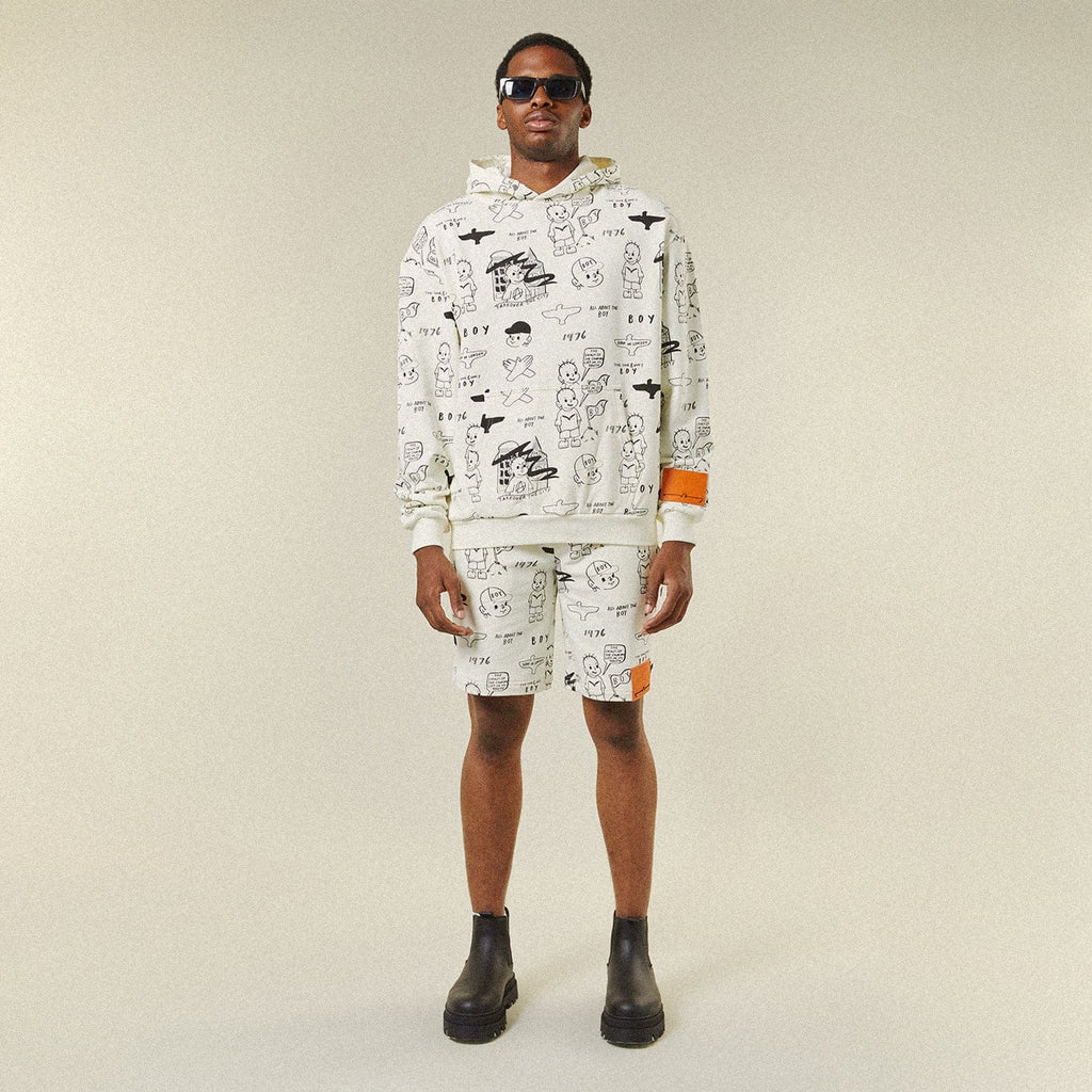 Model wearing BOY London shorts on plain background 