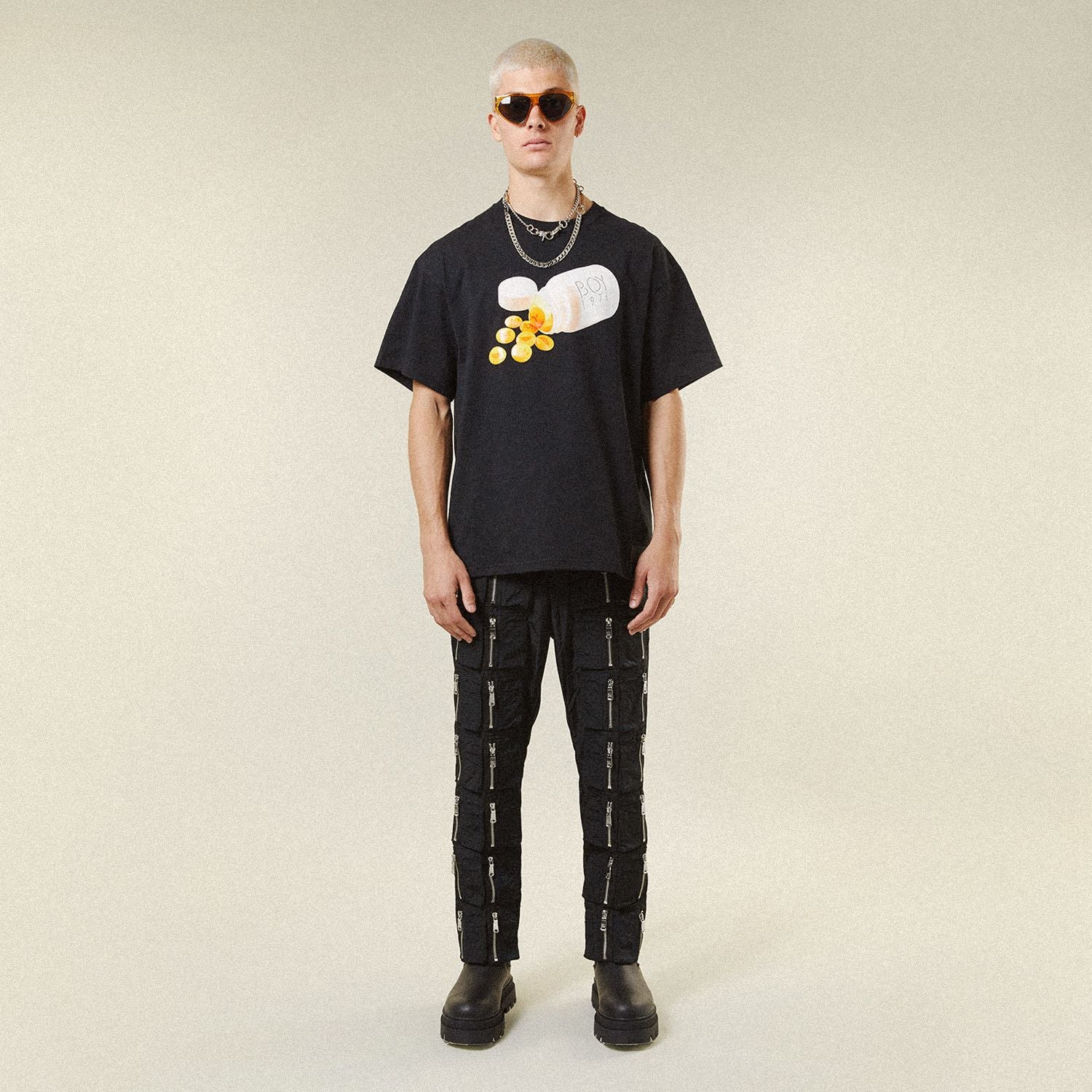 Male model wearing BOY London shirt on plain background