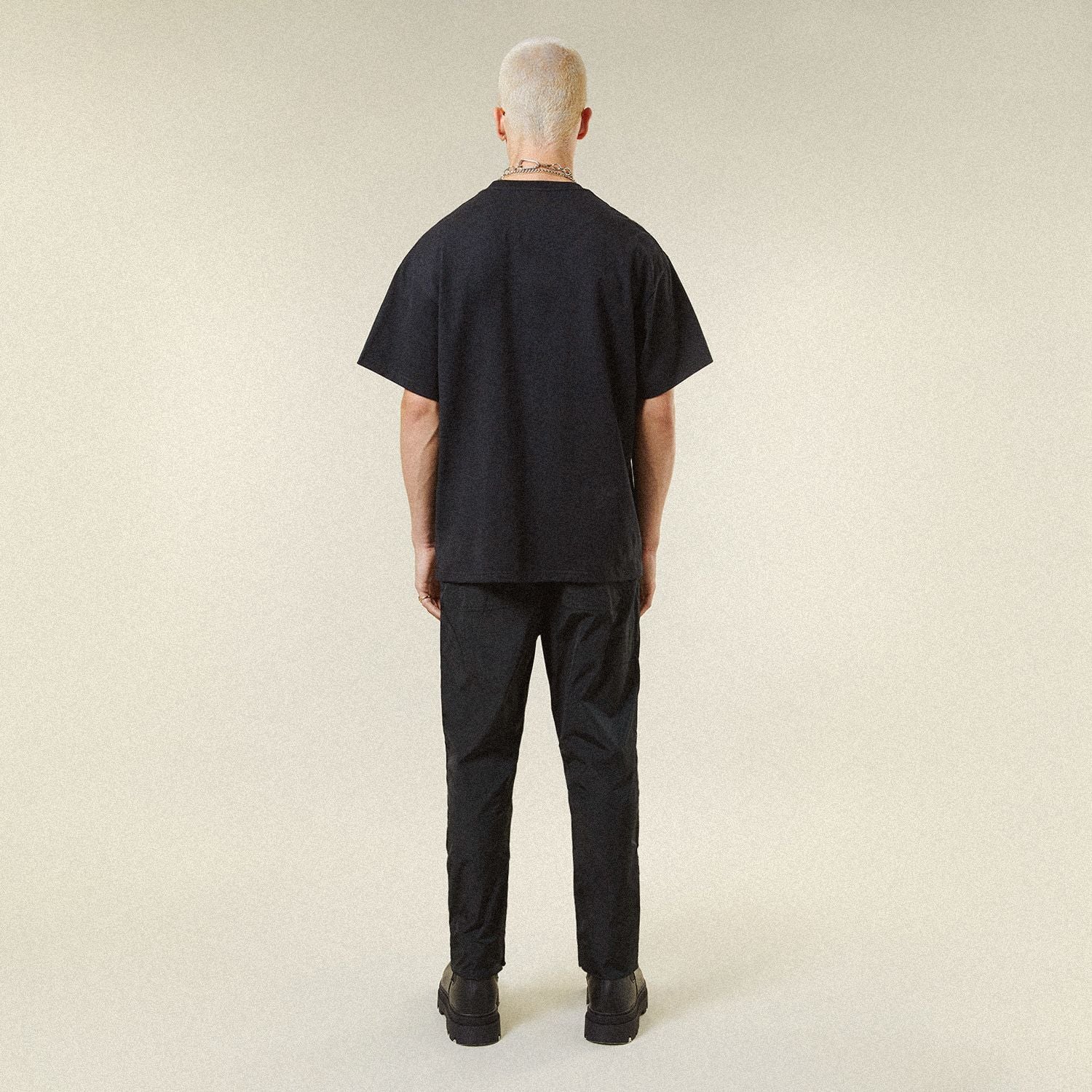 Male model wearing BOY London shirt on plain background