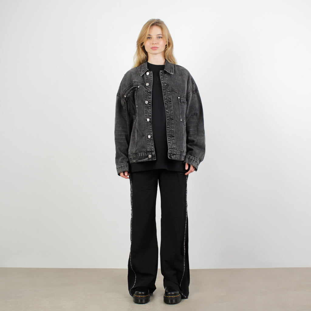 Female model wearing BOY London jacket on white background