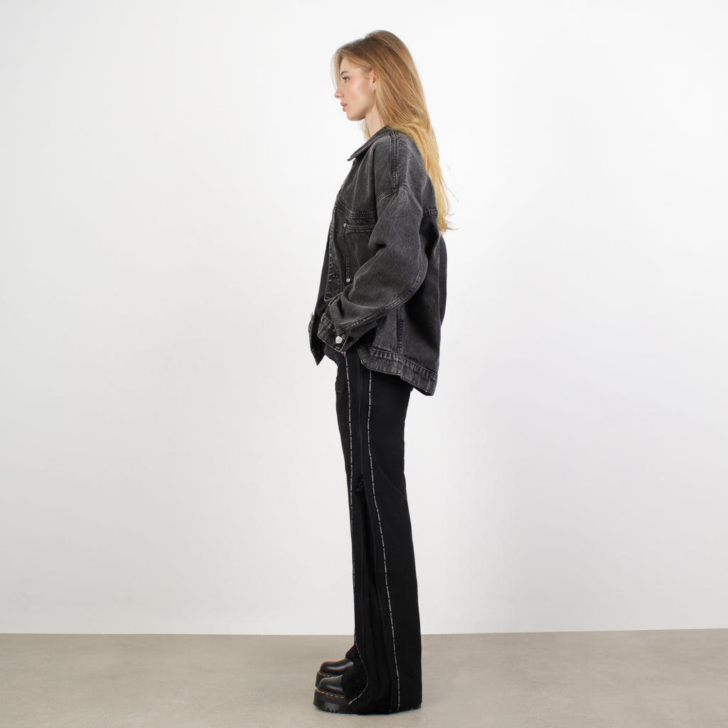 Female model wearing BOY London jacket on white background