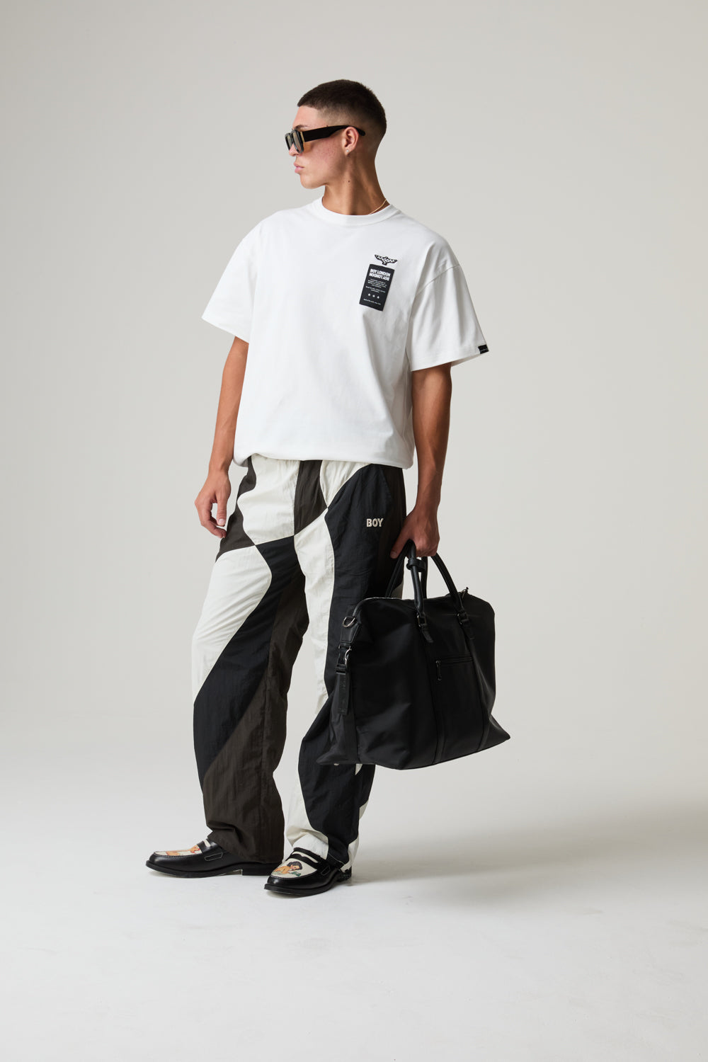 Model wearing a BOY LONDON outfit in-front of a plain background